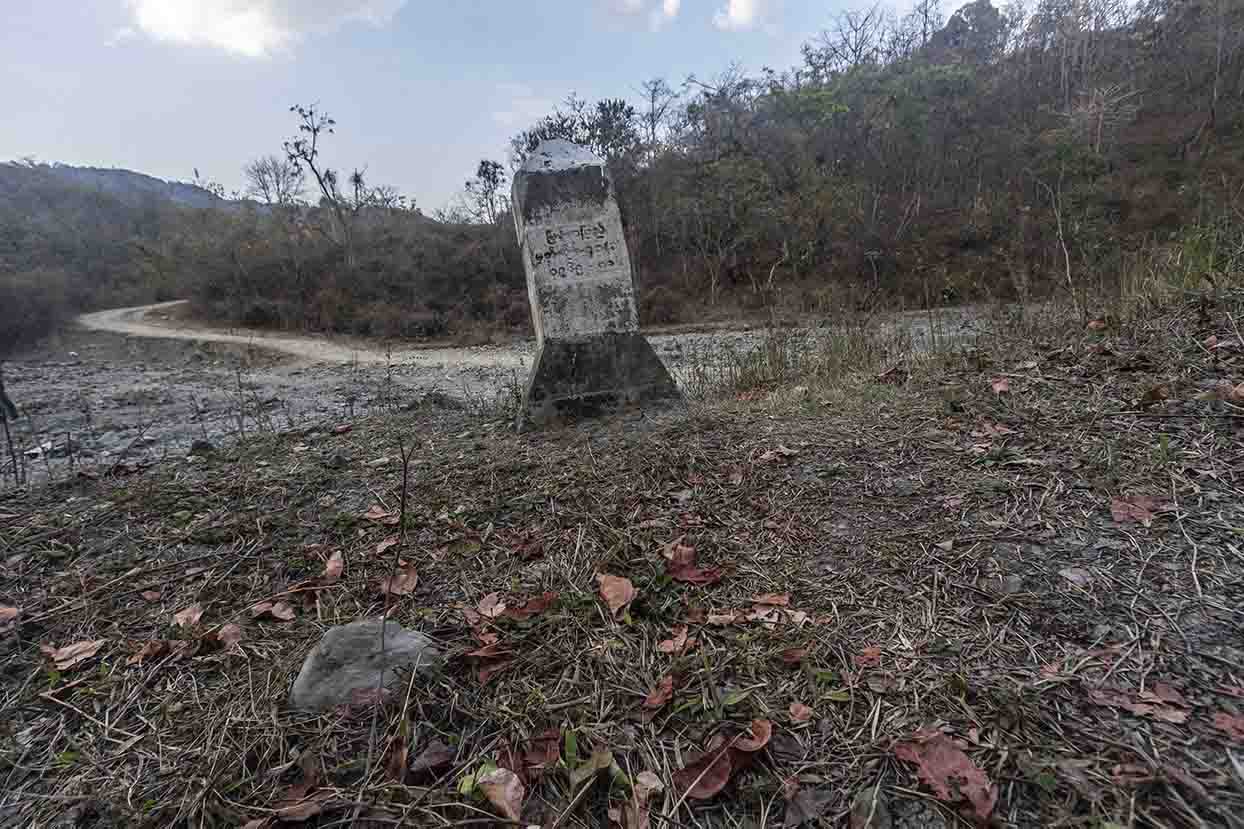 Mynamar side border pillar. The Myanmar script also probably says BP 41(2A). The road climbing out of the river bed on the other side leads to Behiang.